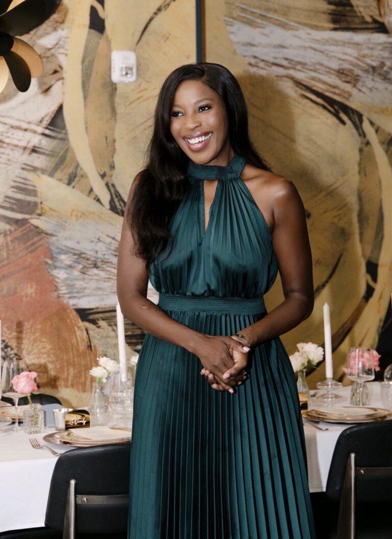 Erica A. Thomas welcoming Supper Club guests in front of the end-of-summer table at Foundation Social Eatery