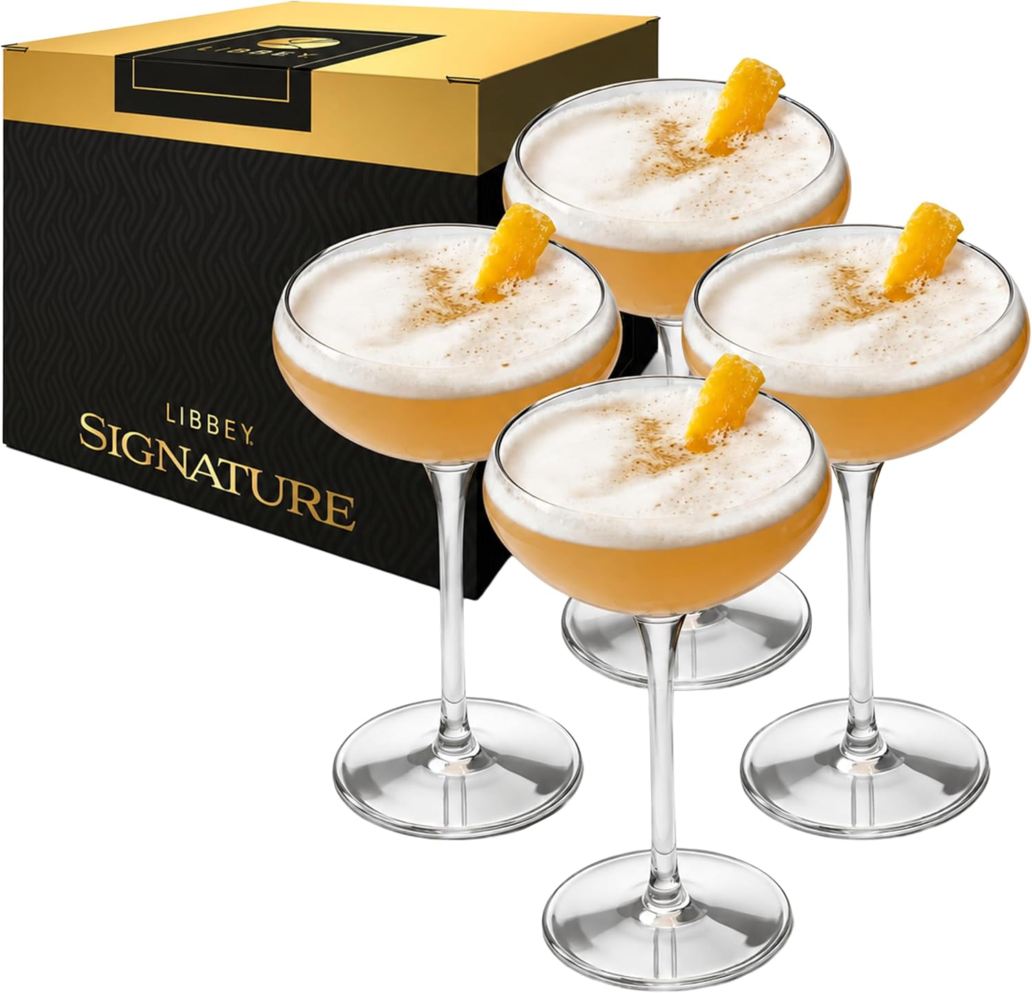 Classic wide-bowled coupe cocktail glasses on a pale surface
