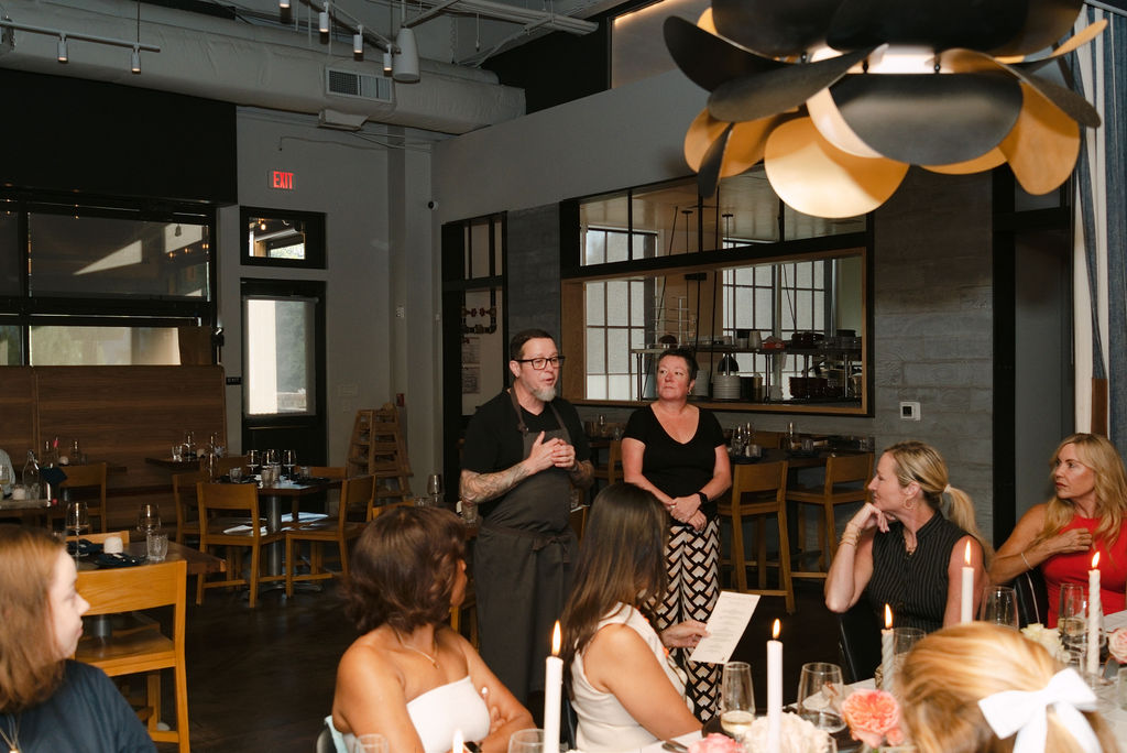 The Foundation Social Eatery team speaking to Eating With Erica Supper Club guests at the dinner table