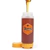 A no-drip squeeze bottle with honey pouring from the spout