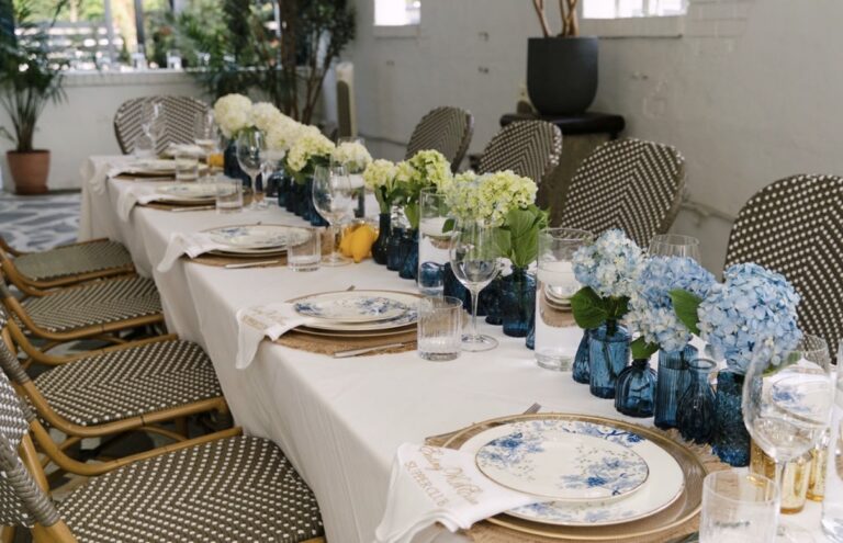The Supper Club table at Kyma lined with hydrangeas moving from blue to white in blue glass vases