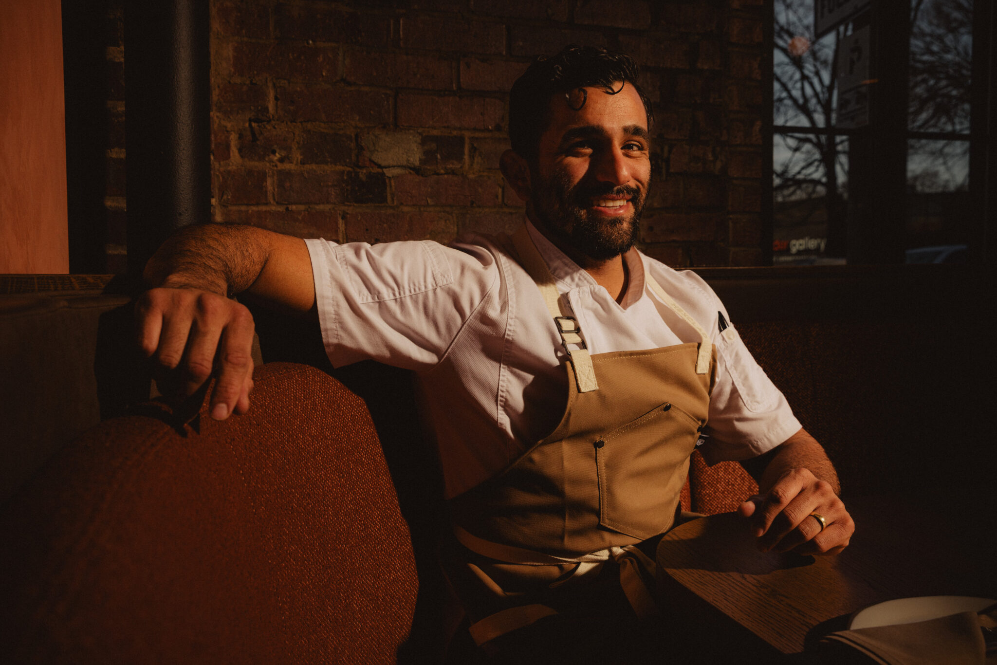 Chef Héctor González-Mora seated in the dining room at The Story of Mi Cariño in Charlotte