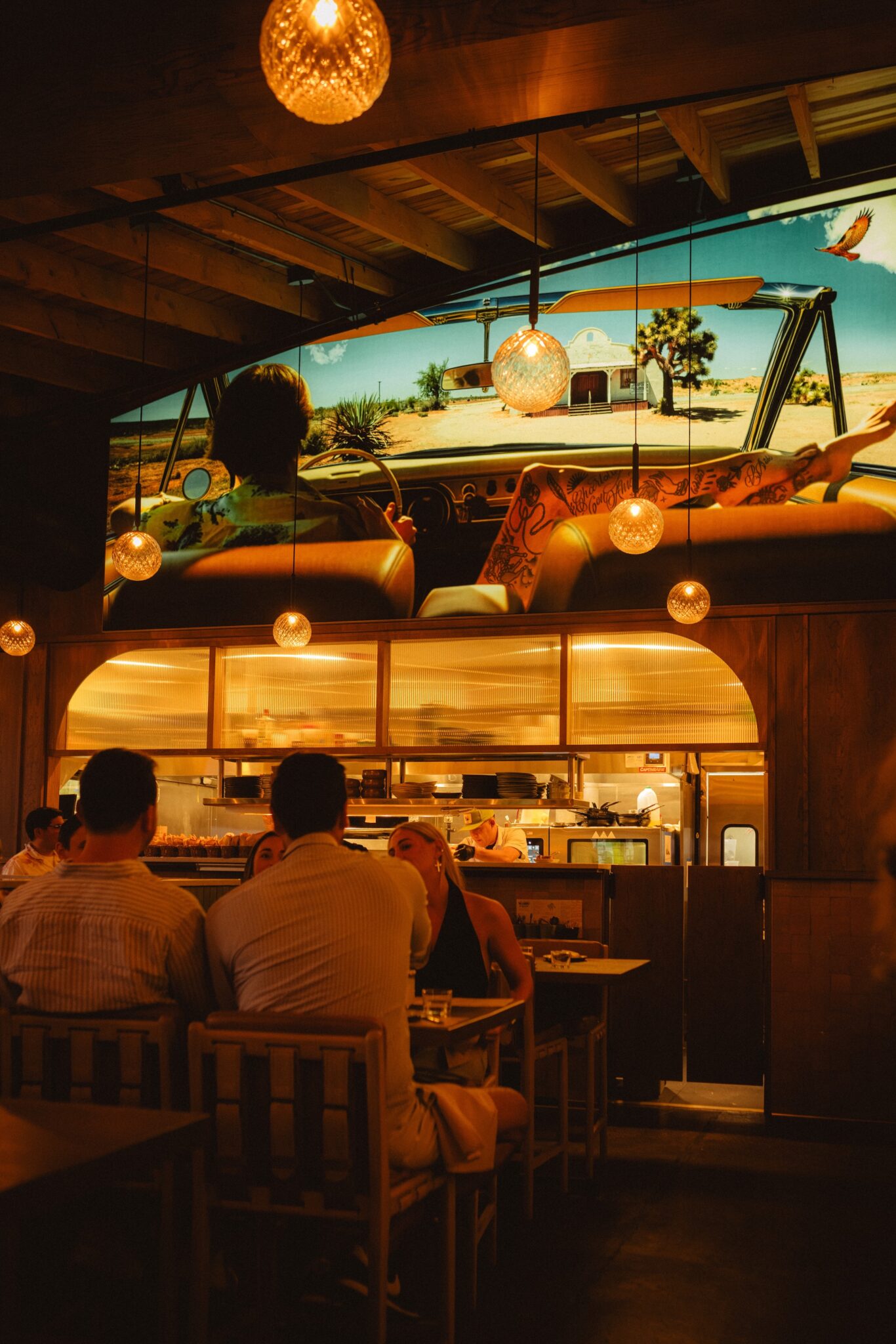 The warmly lit bar and dining room at The Story of Mi Cariño in Charlotte